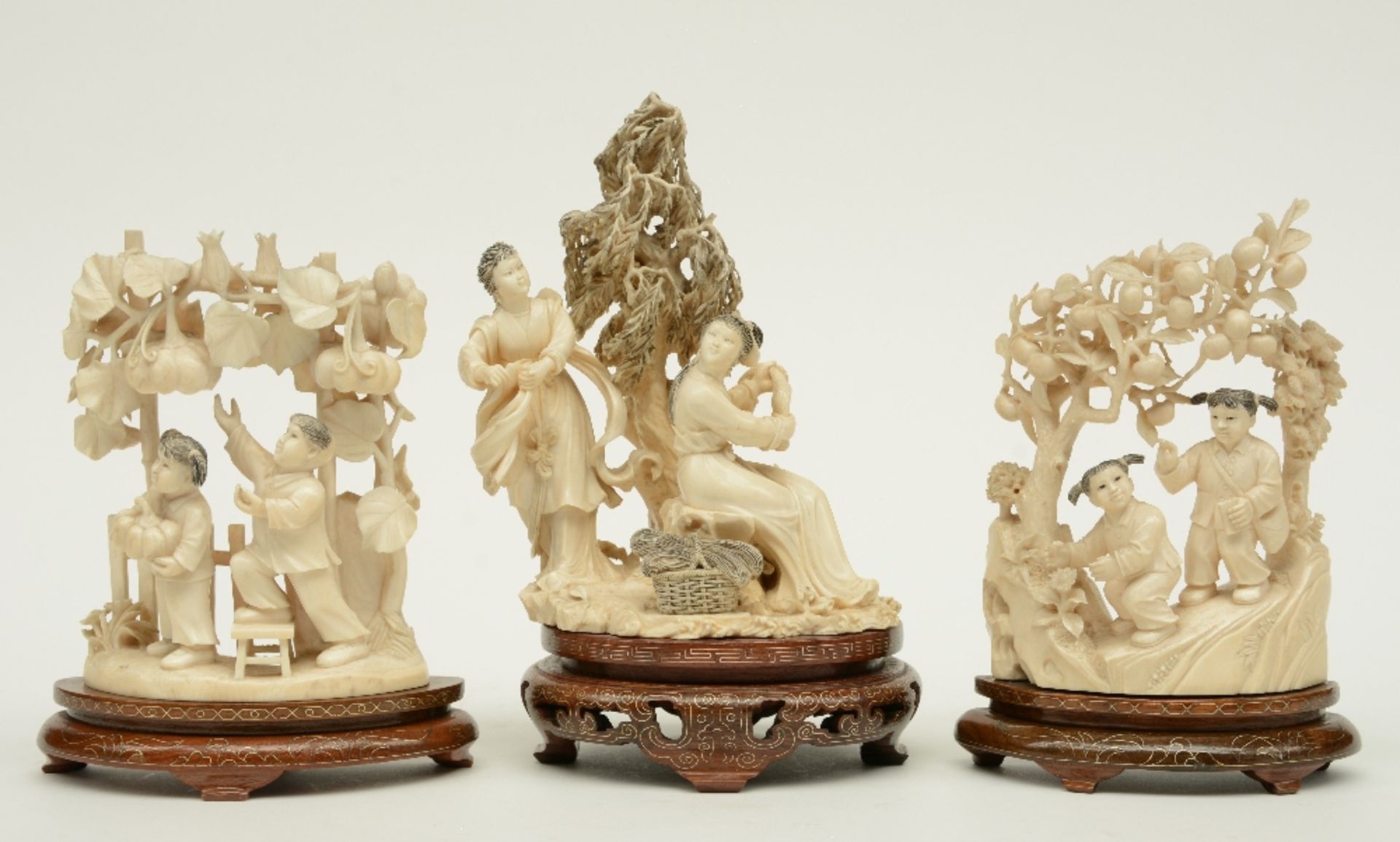 A Chinese ivory sculpture figuring two maiden, scrimshaw decorated, on a wooden base, first half