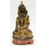 An Oriental polychrome and gilt lacquered wooden seated Buddha, decorated with glass plaques, H 52