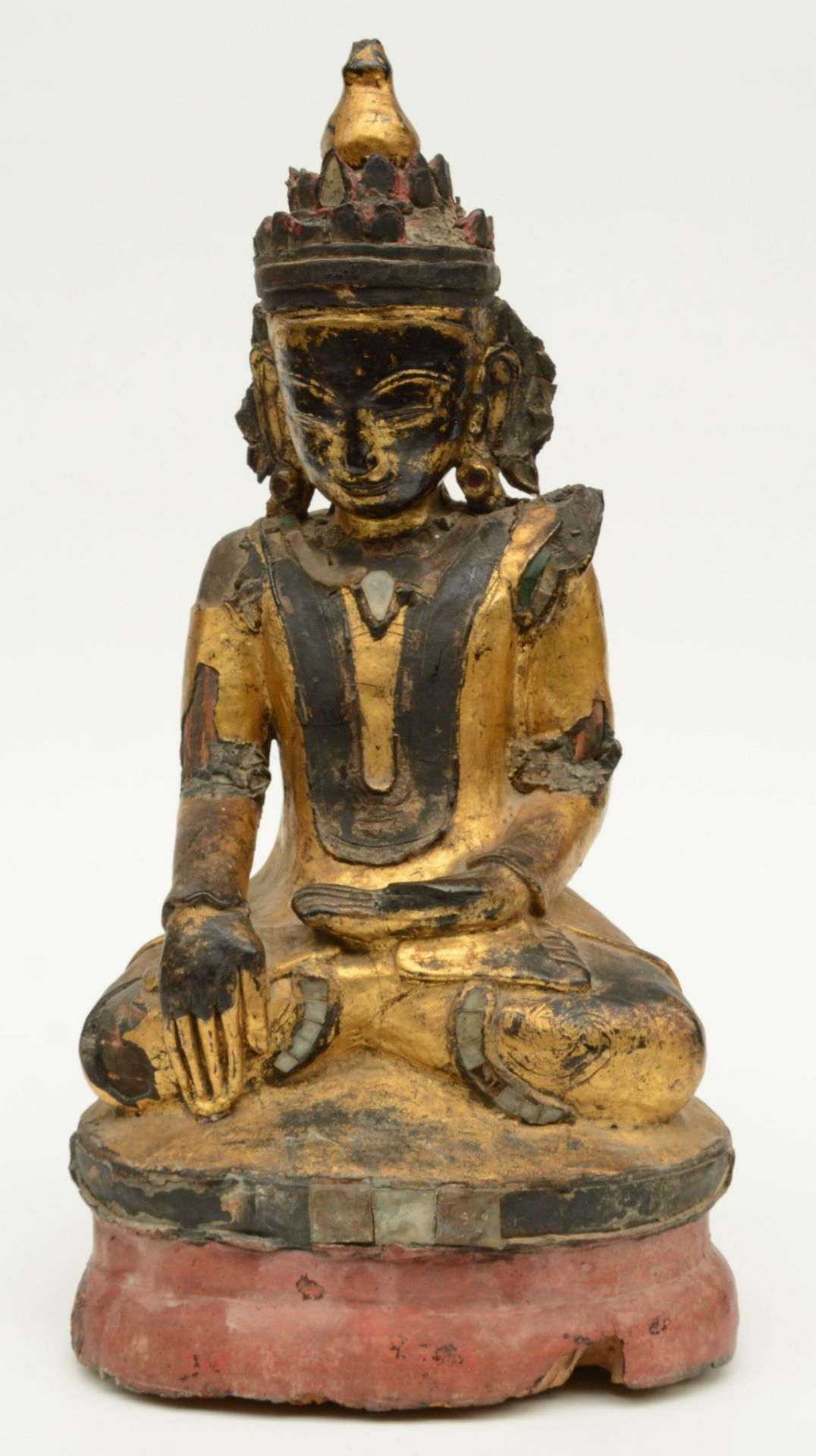 An Oriental polychrome and gilt lacquered wooden seated Buddha, decorated with glass plaques, H 52