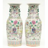 A pair of Chinese famille rose vases decorated with antiquities and symbols, 19thC, H 59 cm (one