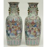 An exceptional pair of Chinese famille rose vases decorated with a court scene and warriors,