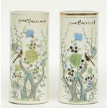 A pair of Chinese cylinder shaped vases, polychrome decorated with a bird and flower branches,