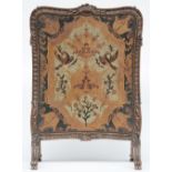 A Rococo style and period sculpted, polychrome painted and gilt fireplace screen, the screen