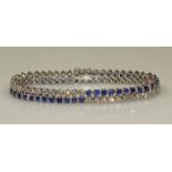 Streifenarmband, WG 750, 49 Brillanten zus. ca. 3.00 ct., 49 runde facettierte Saphire zus. ca. 4.40