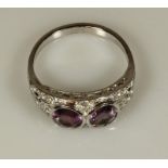 Ring, um 1910/20, WG 750, 2 runde facettierte Amethyste, reicher Diamantbesatz, 5 g, RM 19.5 20.00 %