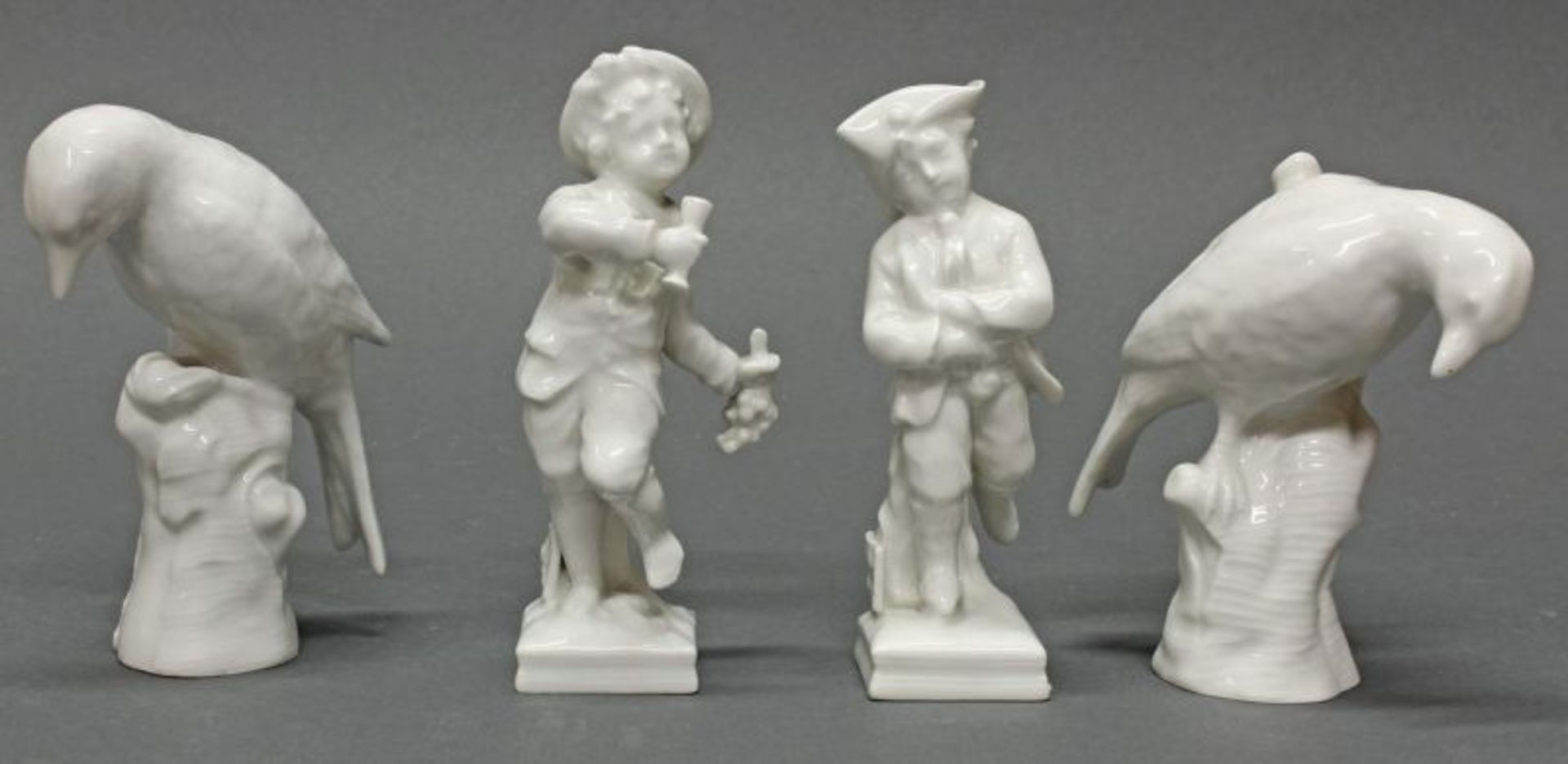 4 Porzellanfiguren, KPM Berlin, Monatsfiguren "Februar" und "Oktober", zwei Vögel auf Stamm,