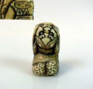 Netsuke "Kniende Gestalt" die Hände am Kopf haltend; tlw. dunkel gefärbt; signiert; H: 4,5 cm