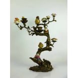 Kerzenständer Bronze; in Astform mit farbig staffierten Vögel und Blüten in Keramik; H: ca. 37 cm;