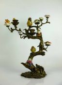 Kerzenständer Bronze; in Astform mit farbig staffierten Vögel und Blüten in Keramik; H: ca. 37 cm;