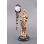 Bronzefigur "Diana"auf rundem Holzsockel. Mit Uhr, Emaillzifferblatt mitarabischen Zahlen und