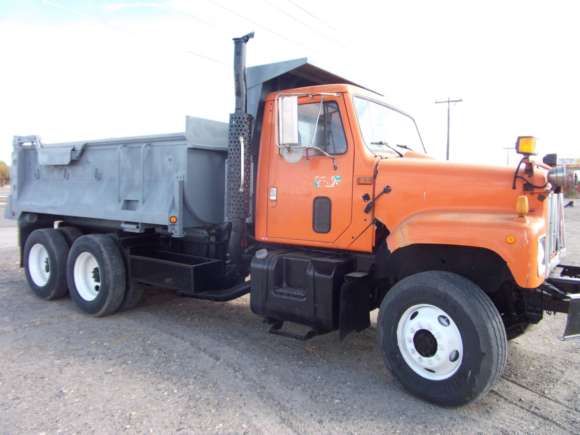 2000 IHC tandem axle dump truck Cummins engine 5spd 2spd hook roll Off quick change 10 yd. Gravel