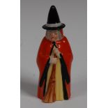 A Royal Worcester candle snuffer, Witch, with pointed hat, red cape and broom, 10cm high,