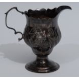 A George III Rococo silver baluster cream jug, embossed with a scrolling cartouche,