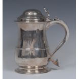 A George II silver baluster tankard, hinged domed cover with C-scroll thumbpiece,