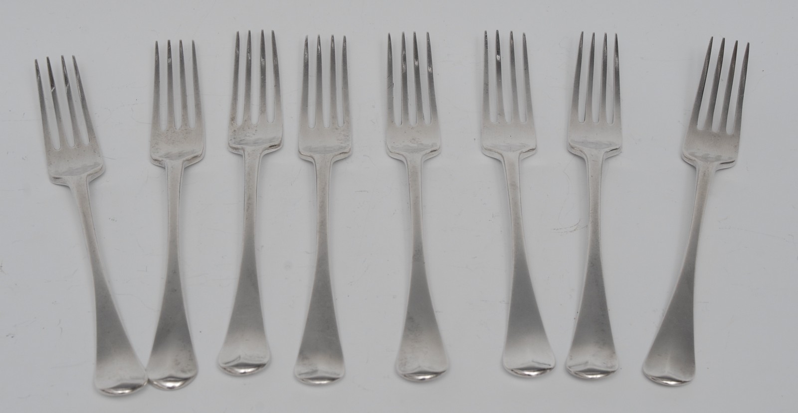 A set of eight George III Provincial silver Old English pattern table forks, John Langlands II,
