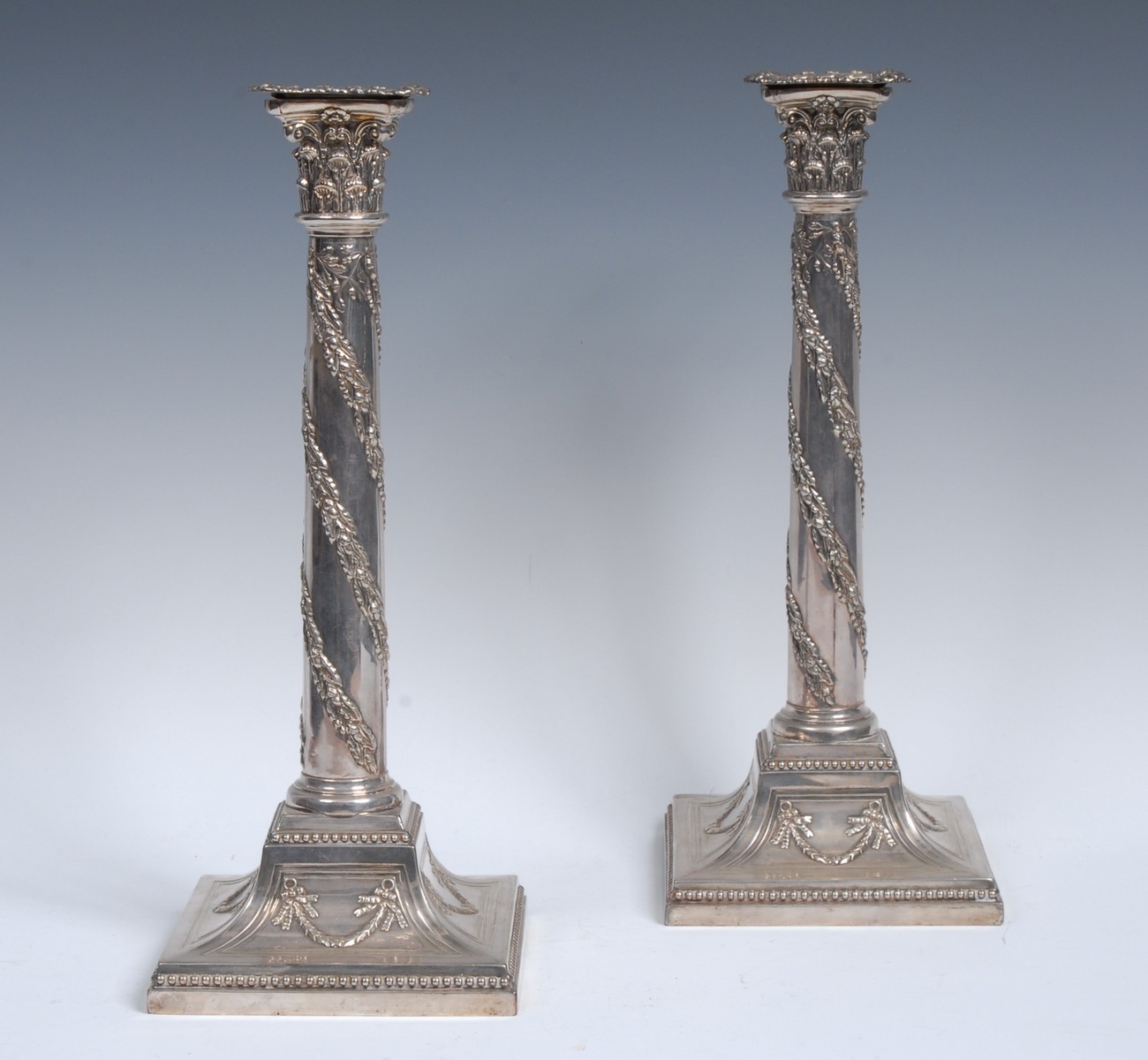 A pair of George III old Sheffield plate Corinthian column table candlesticks,