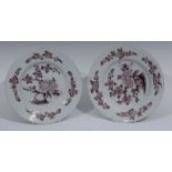 A pair of Delft plates, decorated in manganese with stylized peony and flowerheads, 23cm diam,c.