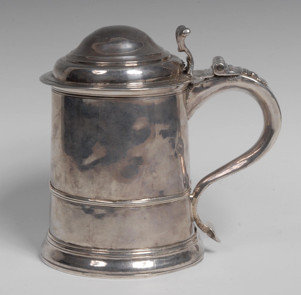 A George I Britannia standard silver cylindrical tankard, hinged domed cover,