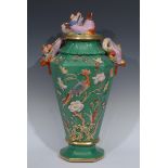 A 19th century Ironstone panelled tapered vase and cover, in relief with fanciful bird perched on