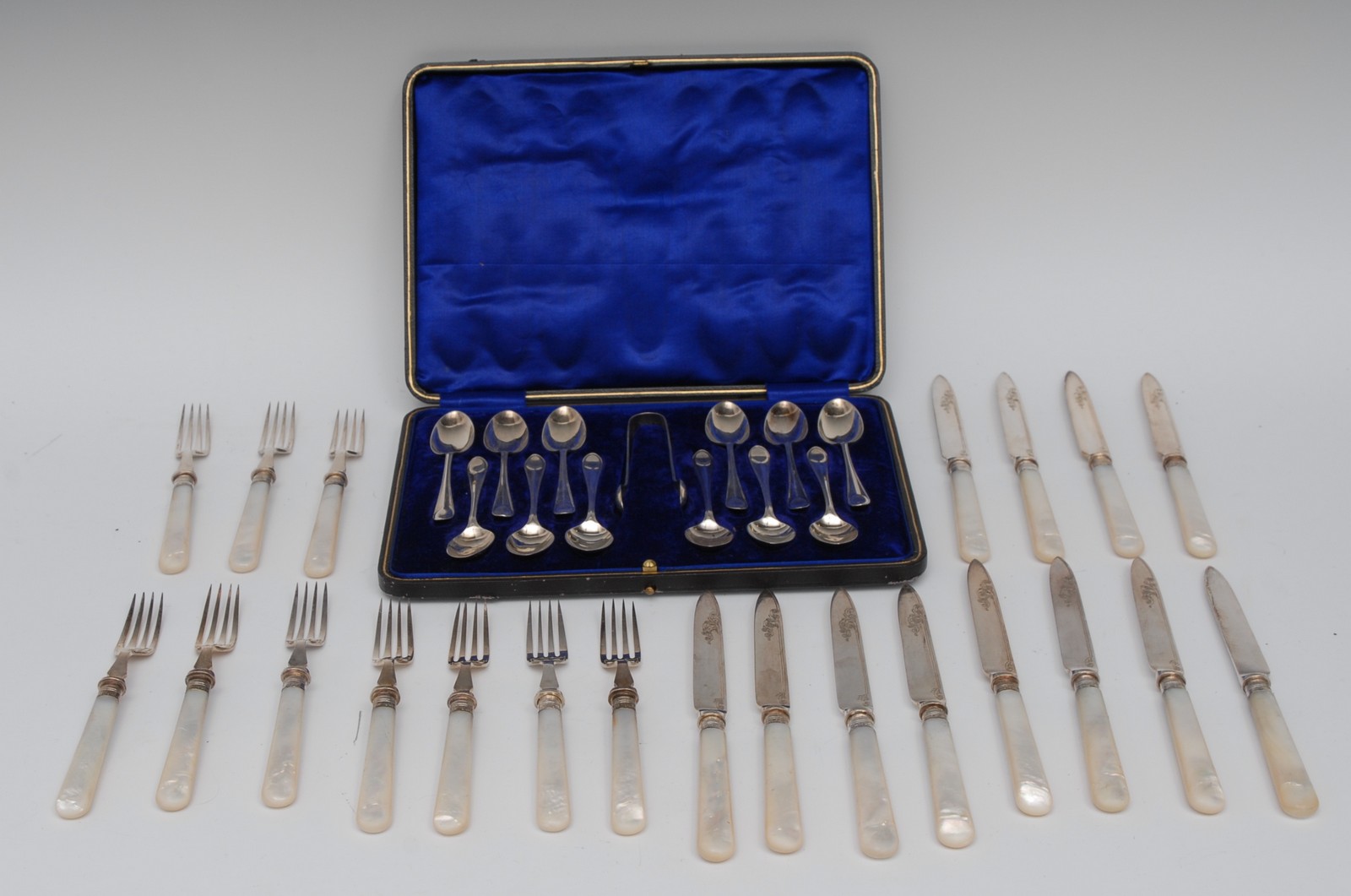 A set of twelve silver tea spoons, bows ensuite, cased,