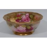 A Royal Worcester bowl, printed and painted with roses and foliage, burnished border, 19.