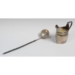 A George III silver helmet shaped cream jug, reeded borders, applied shield shaped cartouche,