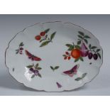 A Chelsea shaped oval plate, painted in polychrome enamels with a fruit,