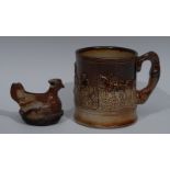 A 19th century brown salt glazed stoneware mug, in relief with huntsmen and hounds at the kill,