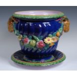 A Minton majolica wrythen moulded jardiniere on stand, the interior in lilac,