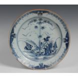A Dutch Delft circular charger, decorated in underglaze blue with stylised bamboo,