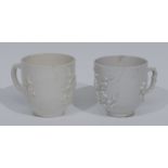 A Bow Blanc de Chine pattern coffee cup, in relief with blossoming prunus, c.