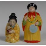 A Royal Worcester candlesnuffer, Mandarin, he stands in yellow and red gown, holding a fan,