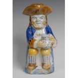 A 19th century Toby jug and cover, seated holding a foaming jug of beer,