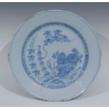 An English Delft circular plate, possibly London, painted with bamboo shoot, peonies and outcrop,