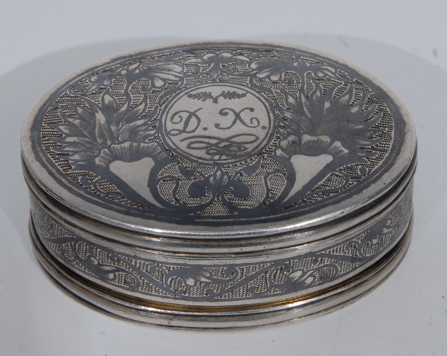 A 19th century Russian and niello double sided 'mean pinch' snuff box, decorated with cornucopia,