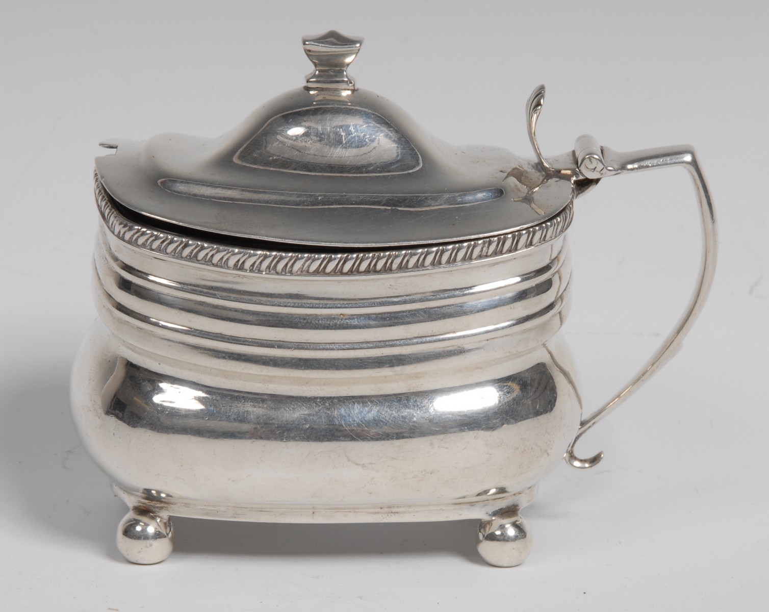 A George III silver boat shaped mustard, hinged domed cover with knop finial, gadrooned rim,