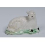 A 18th century Creamware model of a sheep, reclining, lightly coloured in brown and green, 5.