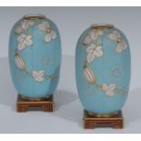 A pair of Minton Aesthetic Movement lobed ovoid vases, in relief with lanterns and foliage,