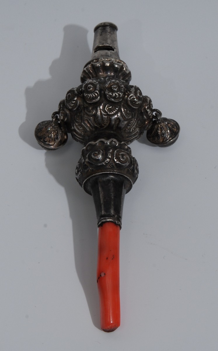 A 19th century silver baby's rattle, embossed and engraved with flowerheads and scrolling leaves,