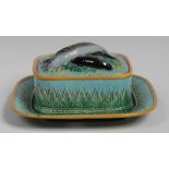 A Staffordshire sardine dish and cover, the domed cover with crossed fish finial,