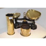 Brassware - a cast iron and brass set of kitchen scales; a trench art brass shell case vase;