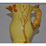 A Burleigh Ware jug, the handle as a squirrel, in yellow overall, picked out in brown,