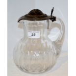 An early 20th century century French silver coloured metal mounted water jug