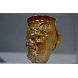 A Brampton Derbyshire salt glazed stoneware Bacchus mug,