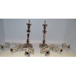 A pair of table candlesticks, campana shaped sconces, tapering cylindrical columns,