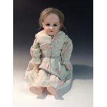 An Armand Marseille bisque head and shoulder doll, impressed 370, A.