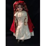 An Armand Marseille bisque headed doll, number 390, with open mouth,