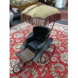 An early Victorian Parker Brothers three wheel coach built pram, black curved body,