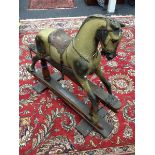 A late 19th/early 20th century Rocking Horse, dappled grey patina, leather saddle, horse hair main,