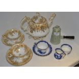A late 19th century Rococo style teapot and teacups;  a Royal Doulton teacup and saucer,